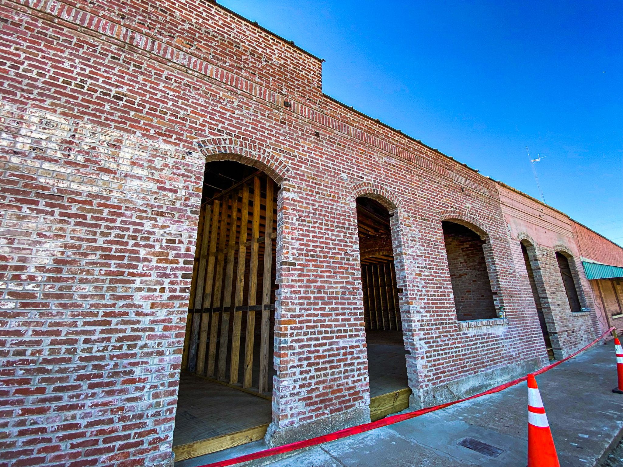 color picture of the side of a brick building in the middle of being preserved