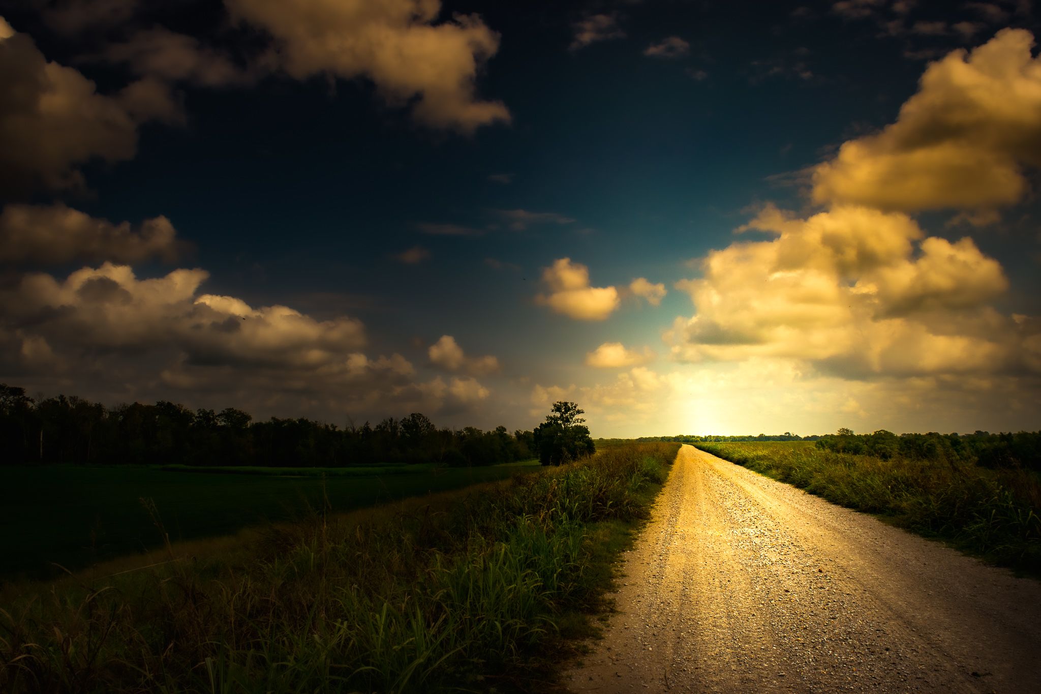 Gravel road with clouds and blue sky